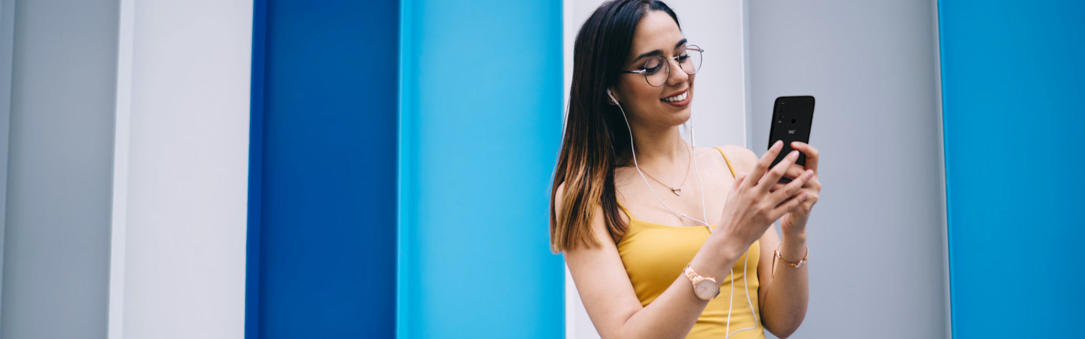 Why Orbic - girl wearing headphones looking at mobile phone